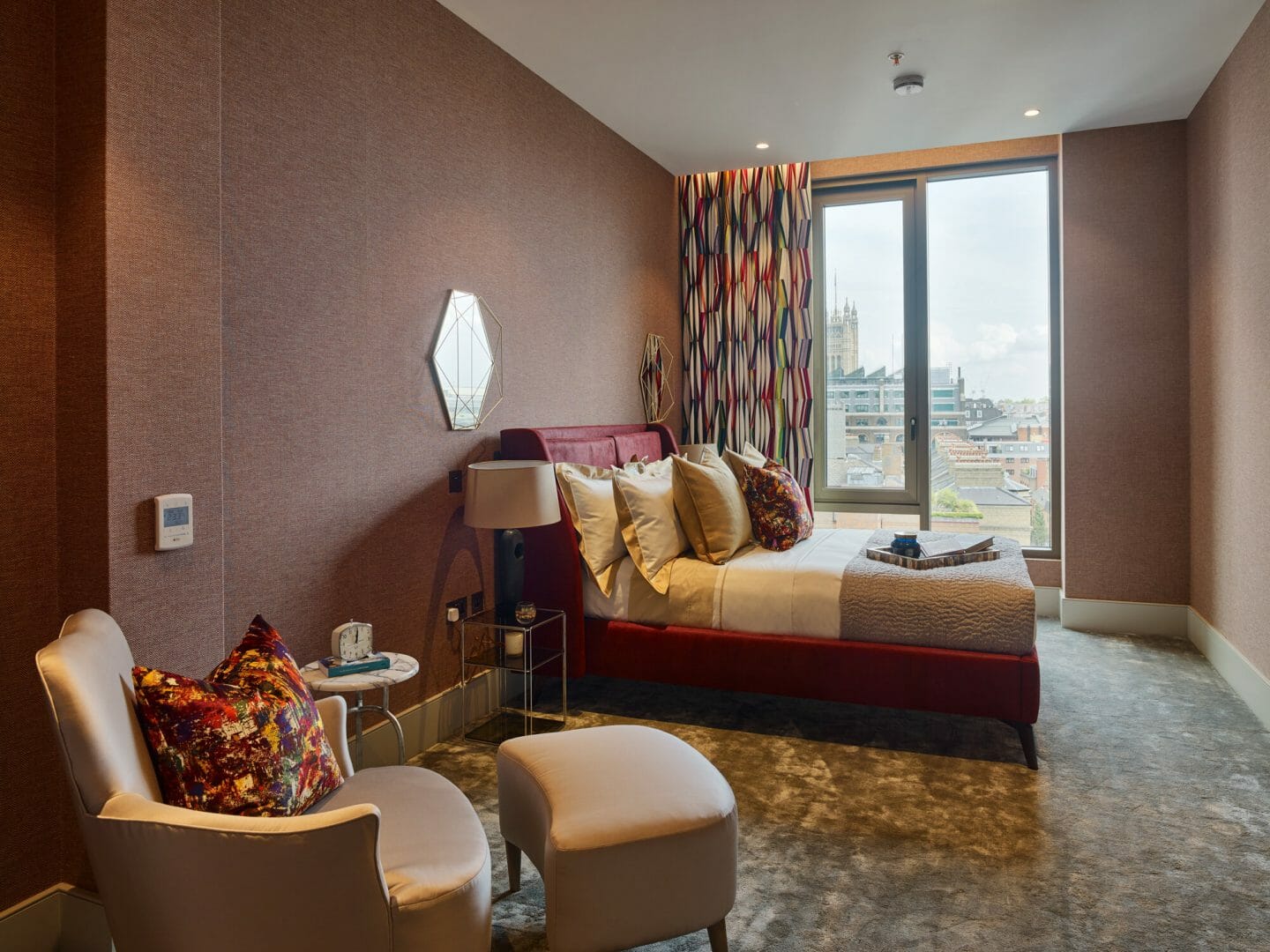 Wallpaper: “Herringbone II” in Blarney Red by Phillip Jefferies. Supplied by: Phillip Jefferies UK. Curtain fabric: Pierre Frey. Bed upholstery: Lelievre. Rug: The Rug Company